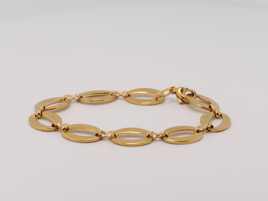 Gold bracelet on a light gray background