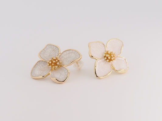 Floral earrings with gold accents on a light gray background