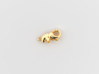 Gold elephant-shaped charm on a light gray background