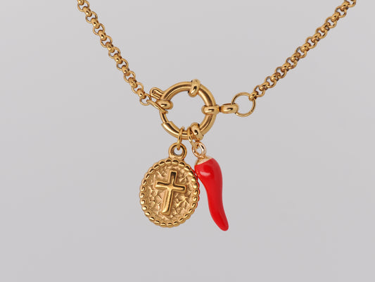 Gold necklace with a red chili pepper charm on a gray background