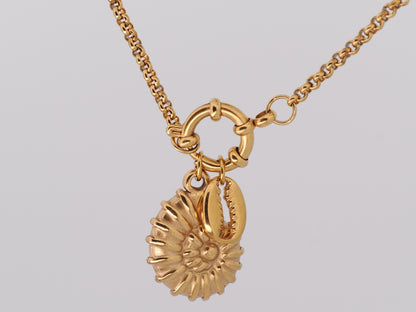 Gold necklace with a sunflower pendant on a light gray background