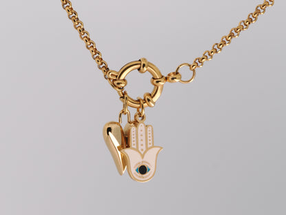 Gold necklace with a Hamsa hand pendant on a gray background