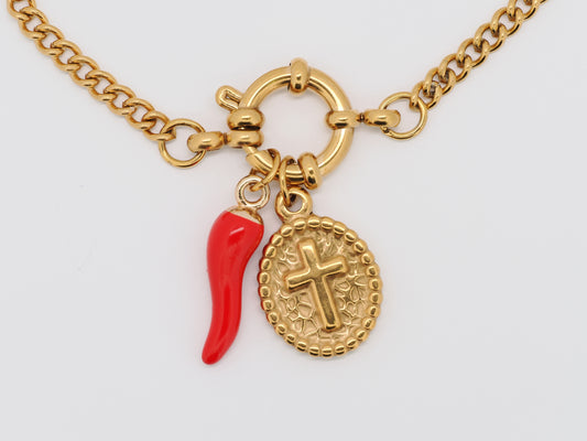 Gold necklace with a red chili pepper charm and a cross pendant on a white background